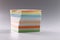 Stack of multicolored sticky notes on gray background