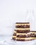 A stack of Nanaimo bars in a white kitchen