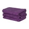 A stack of neatly folded clean fluffy purple towels isolated
