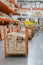stack new wooden bars on shelves inside lumber yard of large hardware store in America. Rack of fresh mill or cut wood timber with