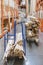 stack new wooden bars on shelves inside lumber yard of large hardware store in America. Rack of fresh mill or cut wood timber with