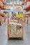 stack new wooden bars on shelves inside lumber yard of large hardware store in America. Rack of fresh mill or cut wood timber with