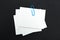 Stack of note paper with blue paperclip. Clipping path included