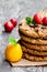 Stack of oat cookies with quince and wild apples on wooden back