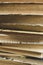 A stack of old books shooting up close. Ancient books in a stack. Old paper in books - a large stack - vertical photo.