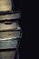 Stack of old dusty shabby books on black background