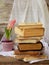 Stack of old hardback books and hyacinth on wooden background. Copy space