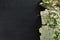 Stack of old torn vintage letters on yellowed paper against black granite table with cherry blossom branch