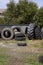 Stack of old used tires of different sizes and types in abandoned scrap yard.