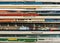 Stack of old vintage comic books creates colorful background texture with abstract shapes and colors