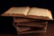 Stack of old worn shabby Jewish books in leather binding in the dark. Open page of Torah. Closeup. Selective focus