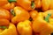 Stack of orange bell peppers on a market stall