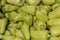 Stack of organic green bell peppers in the marketplace