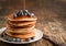 Stack of pancakes with blueberry and maple syrup