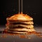 a stack of pancakes are drizzled with syrup
