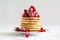 Stack of pancakes with raspberry, red currant, cream and honey