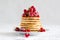 Stack of pancakes with raspberry, red currant, cream and honey