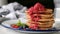 Stack of pancakes with raspberry sauce
