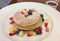 stack of pancakes served with pieces of fresh fruits