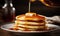 Stack of Pancakes With Syrup Being Poured