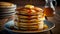 A stack of pancakes topped with honey or maple syrup on the plate. Closeup of a sweet breakfast with butter. Advertise banner.