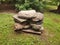 Stack or pile of heavy grey rocks or boulders on wood pallet secured with metal