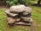 Stack or pile of heavy grey rocks or boulders on wood pallet secured with metal