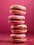 A stack of pink berry macarons with hazelnut ganache filling