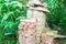 Stack of pink concrete floor tiles in garden. Pile of red and gray paving stone for patio