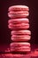 A stack of pink macarons with berry ganache filling, traditional french dessert