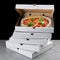 Stack of pizza box with pizza inside. pizza delivery. box on black background. meat pizza