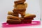 Stack of plain melba toasts on white Background. Edible square dry toast slices. Delicious crispbakes square cookies. Breakfast