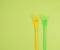 stack of plastic forks on a green background
