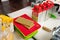 A stack of plastic slicing boards next to four hand-held steel grates and a packet of flour