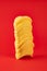 Stack of potato chips in bright red background. Minimalistic image of attention grabbing fast food in vivid colors