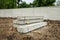 Stack of precast concrete wall panels on fresh ground floor,to build a wall on the construction site outside