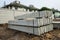 Stack of precast concrete wall panels on fresh ground floor,to build a wall on the construction site outside