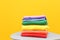 Stack of rainbow clothes on table