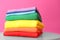 Stack of rainbow clothes on table