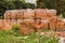 Stack of red brick for construction. Common quality building bricks stacked ready for use.