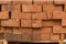 Stack of red brick for construction. Common quality building bricks stacked ready for use.