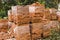 Stack of red brick for construction. Common quality building bricks stacked ready for use.