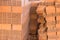 Stack of red clay brick. Warehouse. Storage of products made of