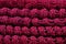 Stack of red melange openwork knitted fabric