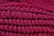 Stack of red melange openwork knitted fabric