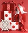 Stack of red and white polka dot theme festive gift box presents with ornaments