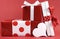 Stack of red and white polka dot theme festive gift box presents with white heart