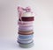 A stack of reels with multi-colored reps ribbons for decoration and packaging of gifts and bouquets with bow