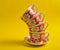 Stack of retro cups on a yellow background