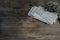 Stack of retro monochrome photographs of 50-60s on natural wooden table, reverse side of photo, dried flowers, concept of family